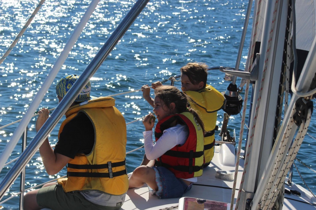Family in life jackets sailing on Pittwater