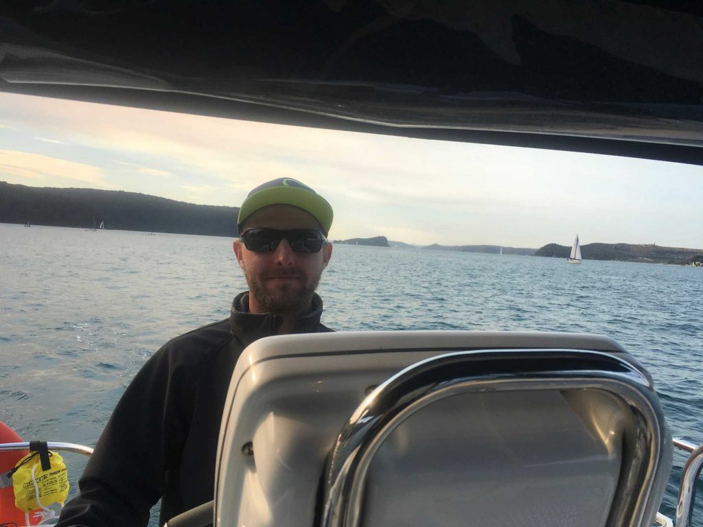 Paul at the helm of Sha Meduza on Pittwater