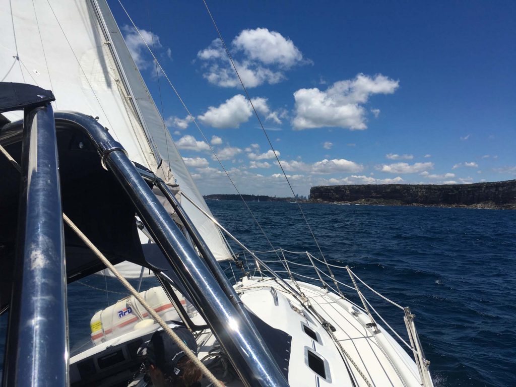 Sailing past a Pittwater headland with the headsail drawing