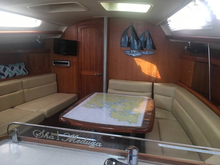 Saloon table and settee below deck on Sha Meduza